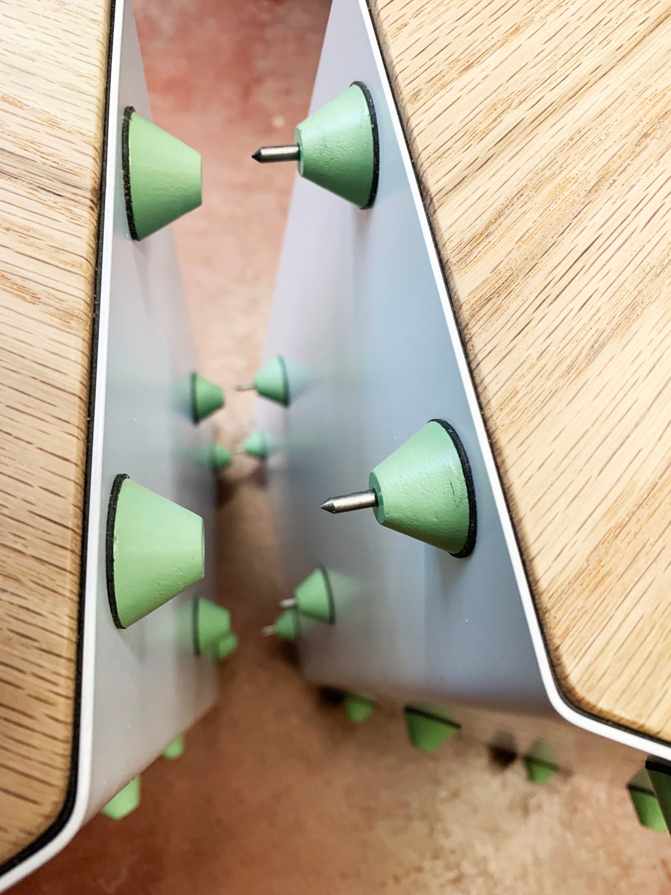 Green spacers with steel pins installed inside the base