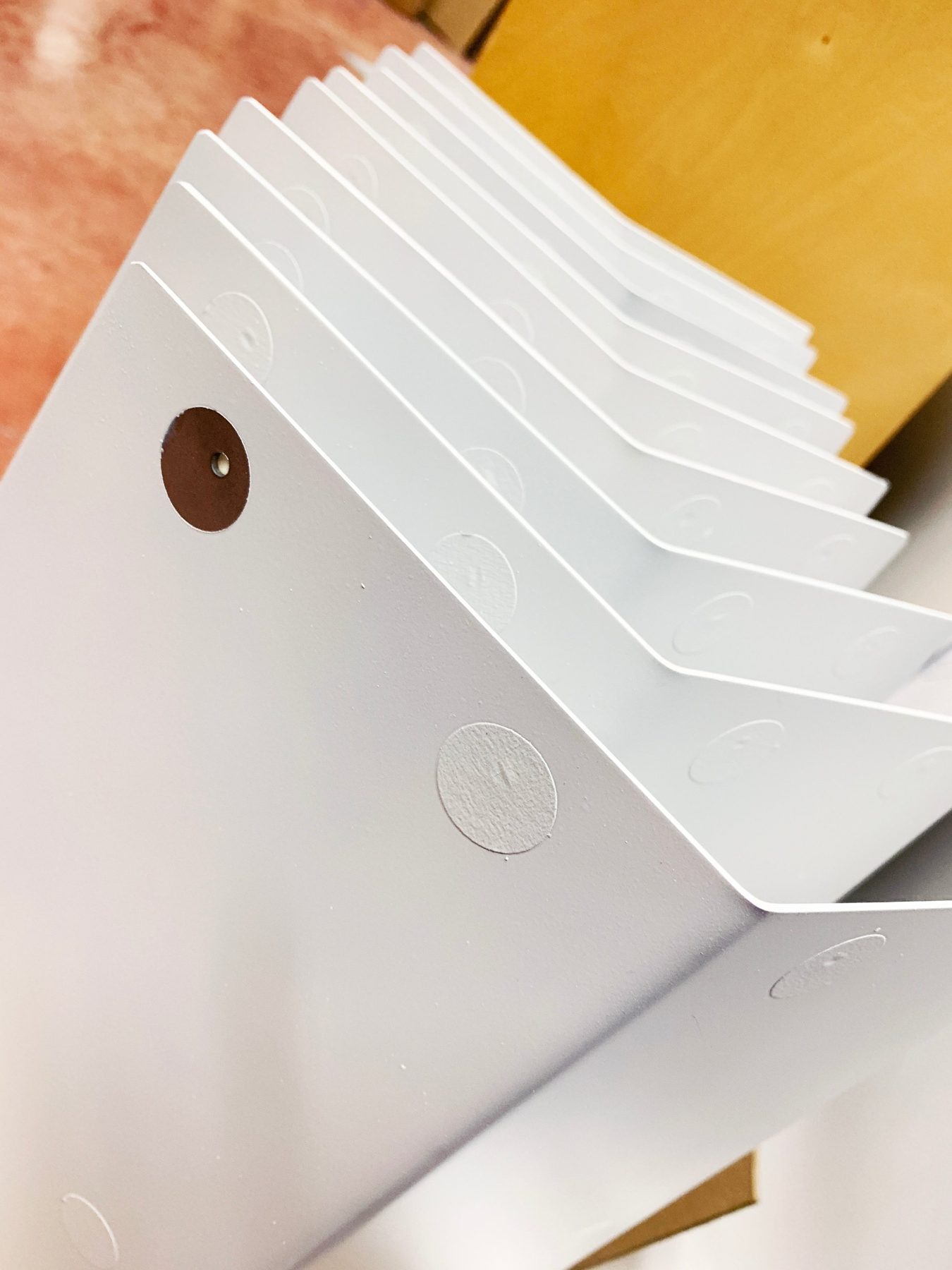 Stack of powder coated bent sheet metal bases