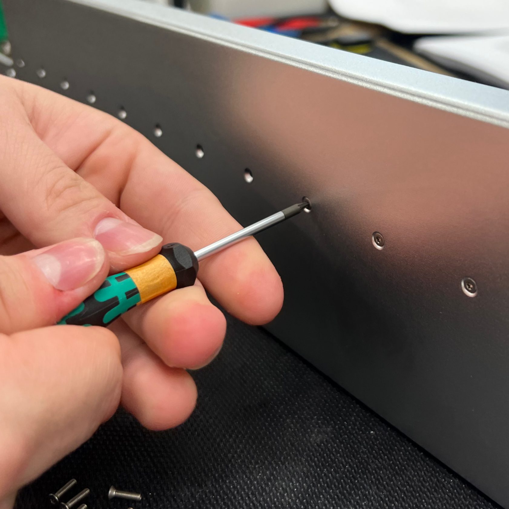 Bolting the X-axis linear rail onto the upper body.