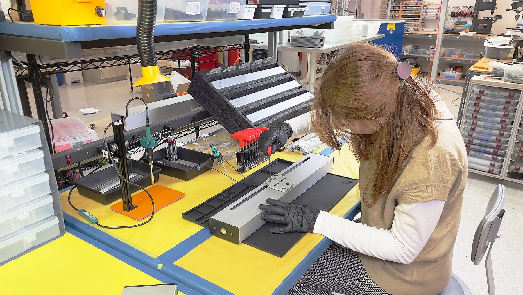 Sophie assembling an Optic lower body at the production station